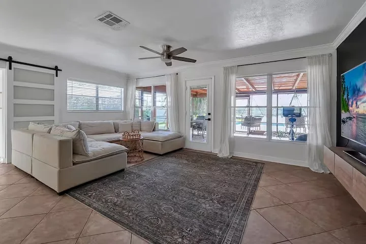 Open living room of a vacation home with pool view