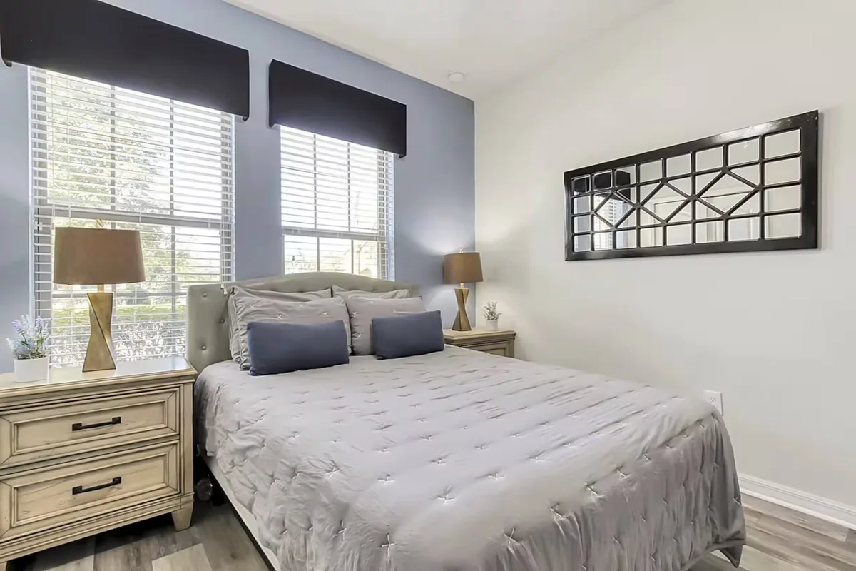 Neatly made queen bed in a bright Orlando home